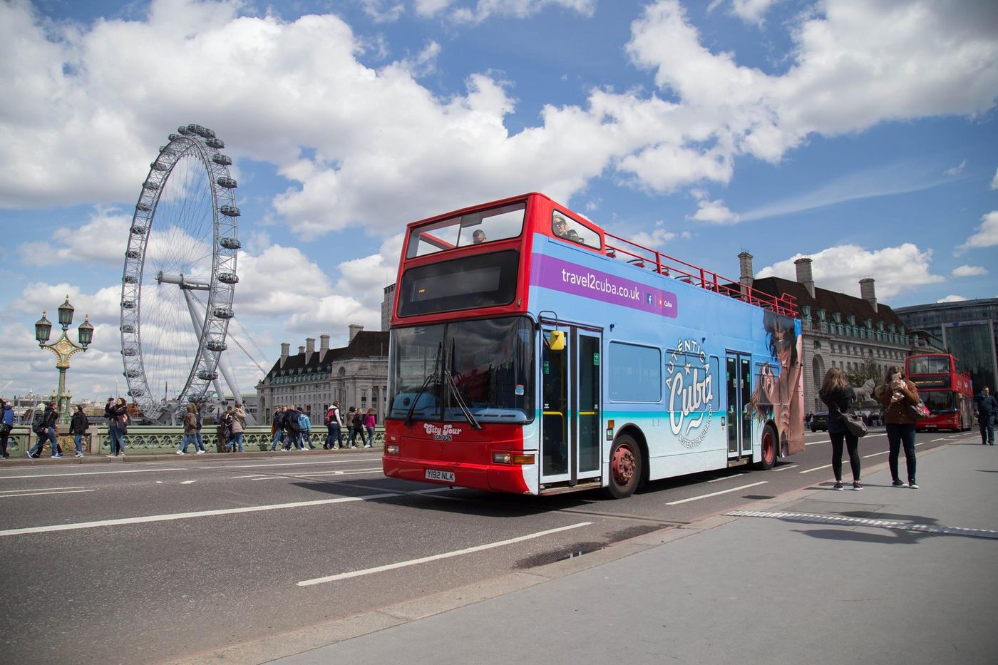 Travel2Cuba open-top bus wrap by the London Eye